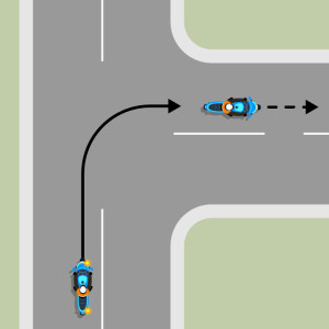 A blue motorcycle travelling on a laned road, indicating and turning right.