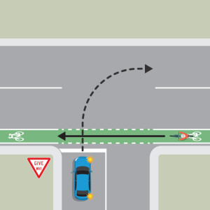 A blue car is indicating right to turn onto the continuing road from a driveway. A bicycle is approaching from the right on a footpath. The blue car must give way to the bicycle.