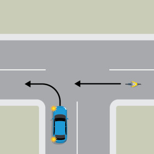 A blue car is indicating left to turn onto the continuing road of a T intersection. A cyclist is approaching from the right in the lane the blue car wants to enter.