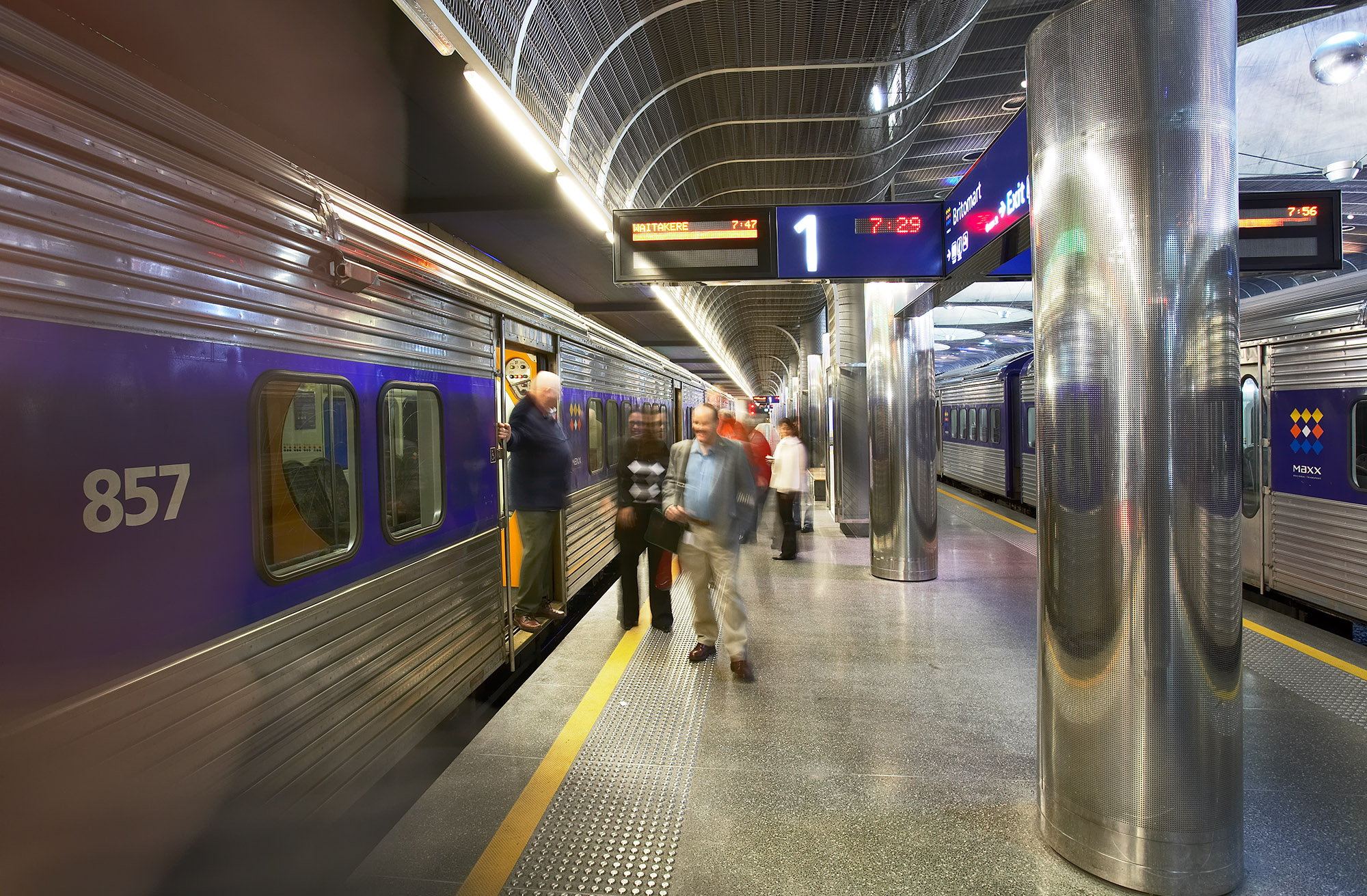 Passengers on platform at Britomart Station with man on left exiting a train