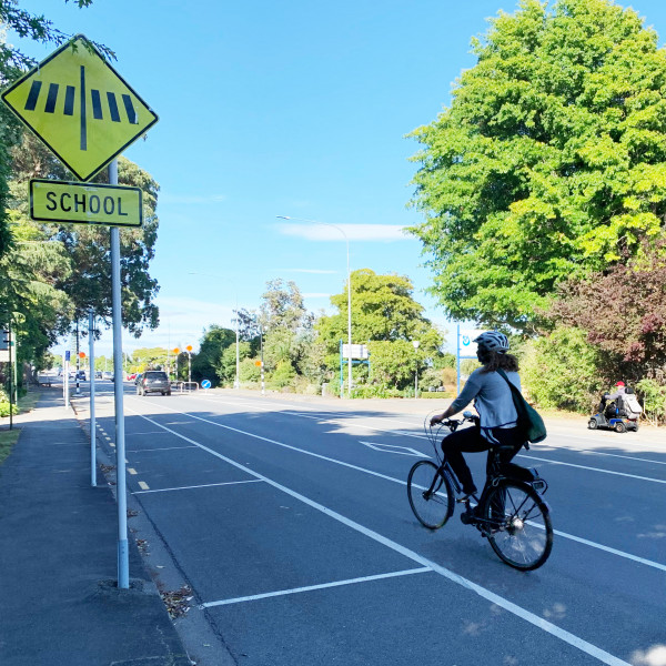 Woman riding bike in cycle lane